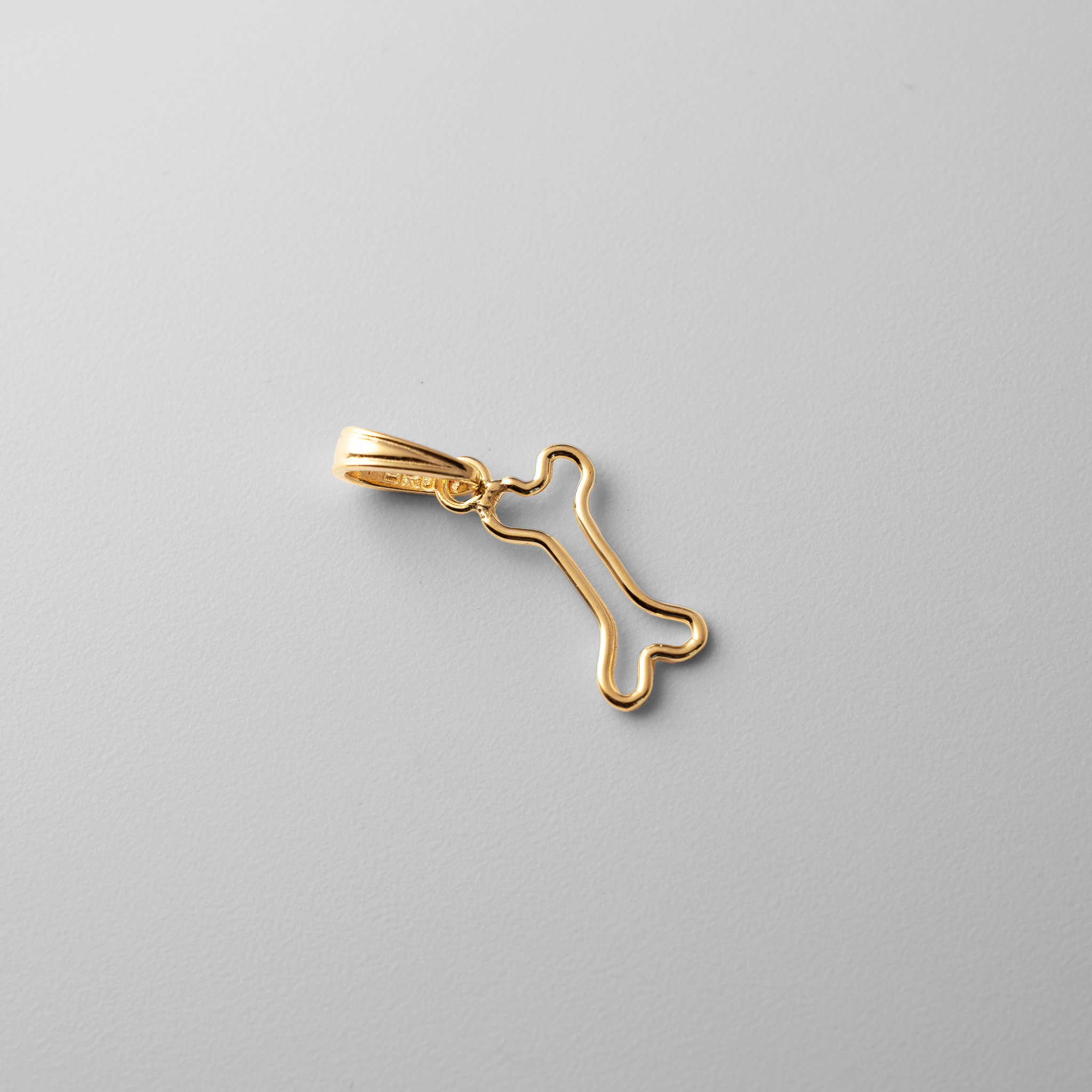 Gold Cut-Out Dog Bone Pendant - Charlie & Co. Jewelry