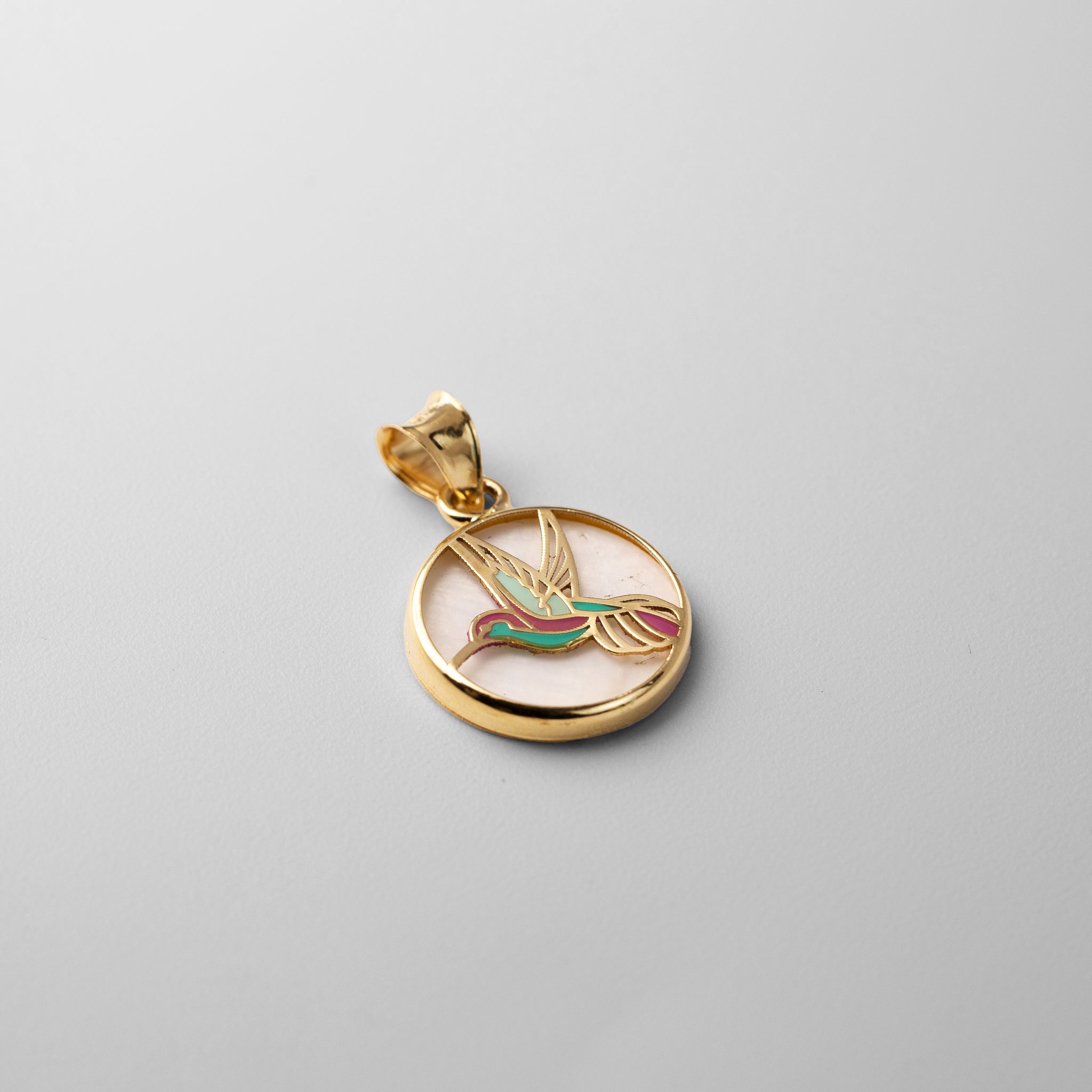 Gold Hummingbird Round Pendant With Mother of Pearl Backdrop - Model PT2519 - Charlie & Co. Jewelry