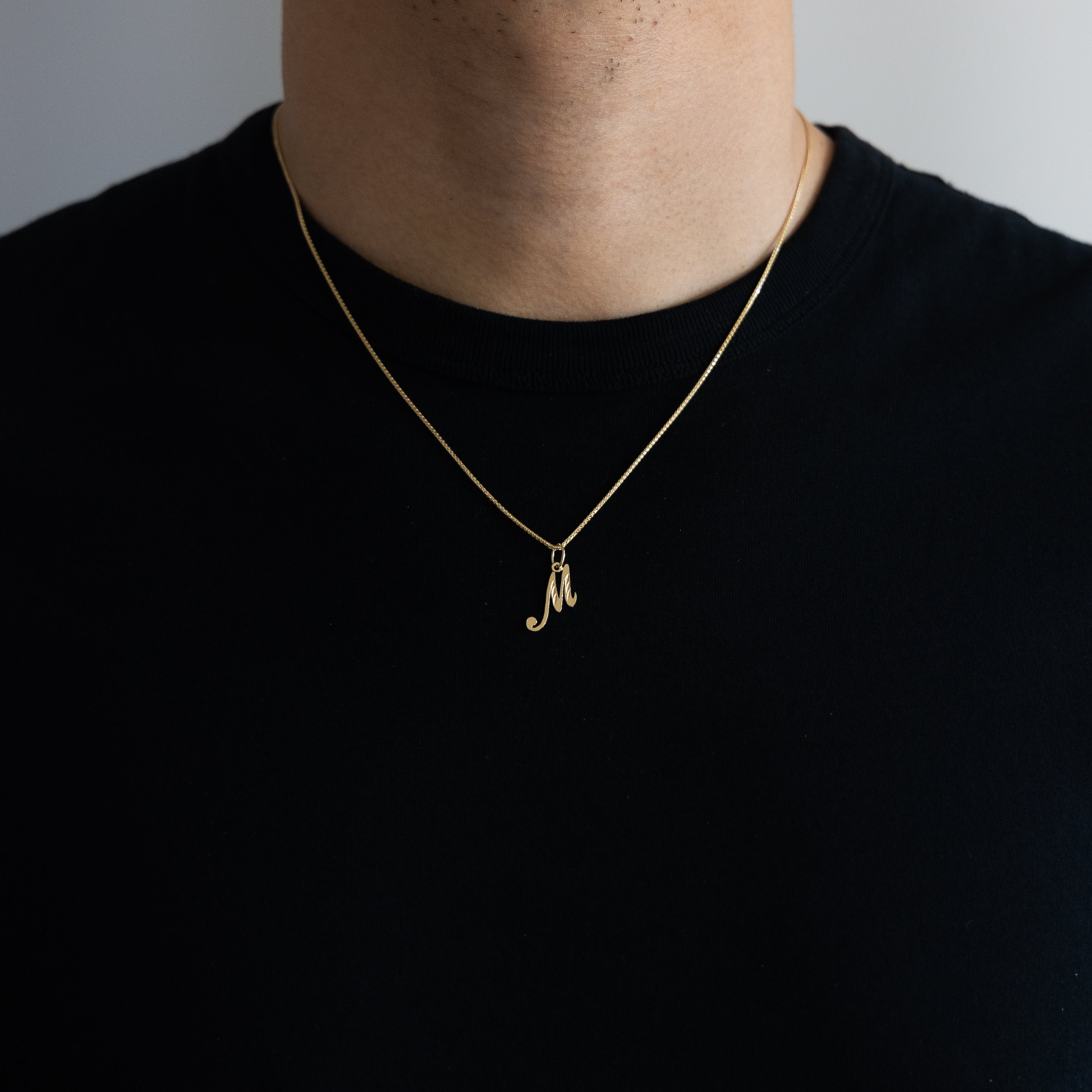 Gold Calligraphy Letter M Pendant | A-Z Pendants - Charlie & Co. Jewelry
